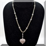 J128. Gold tone beaded necklace with diamond heart pendant hanging from 3 pave diamond beads. 